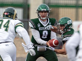 Mason Nyhus hands the ball to now-former Huskie Adam Machart during a game last October.