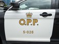 An Ontario Provincial Police cruiser sits outside of a press conference in Vaughan, Ont., on June 20, 2019. The Ontario Human Rights Tribunal has found provincial police discriminated against migrant workers based on their race when they conducted a DNA sweep as part of a 2013 sexual assault investigation.
