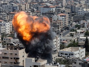 Flame and smoke rise during an Israeli air strike, amid Israel-Gaza fighting, in Gaza City on Aug. 6, 2022.