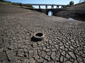 Low water levels at Baitings Reservoir reveal an ancient pack horse bridge as drought conditions continue in the heatwave in Ripponden, England, Friday, Aug. 12, 2022.