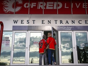 Calgary Flames fans enter the Saddledome for pre-season NHL hockey action in Calgary on Sept. 26, 2021. The Calgary Sports and Entertainment Corporation is hiring an organist to hype up the crowds at professional hockey games, a position that hasn't been vacant for more than three decades.
