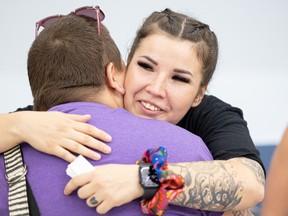 Cheyenne McDonald, community outreach coordinator at the Elizabeth Fry Society, gets a hug from Elizabeth Fry's executive director Kayleigh Lafontaine after speaking at the Saskatoon Indian & Metis Friendship Centre on international overdose awareness day.