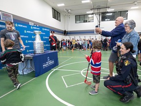 Washington Capitals Stanley Cup champion goalie Darcy Kuemper shows off the Stanley cup to members of the Saskatoon Police Service and their families on Aug 5, 2022.