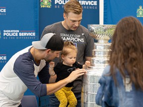 Travis Chomin wins the Stanley Cup with his daughter Maddie Chomin and Stanley Cup champion goaltender Darcy Kemper of the Washington Capitals at the Saskatoon Police Service's gymnasium on August 5, 2022. I'm watching it.