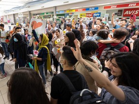 Thousands of people waited to welcome a group of Afghan refugees at Saskatoon International Airport on August 27, 2022.