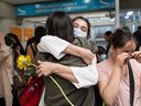 Refugee students from Marefat High School in Kabul, Afghanistan, embrace each other after being reunited with their former classmates at Saskatoon International Airport on Saturday, Aug. 27, 2022.