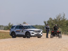 An RCMP officer talks with a resident on James Smith Cree Nation after reports of a possible sighting of Myles Sanderson on the reserve. Photo taken in James Smith Cree Nation, SK on Tuesday, September 6, 2022.