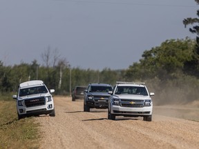 RCMP vehicles drive through James Smith Cree Nation in connection with the multiple fatal stabbings on Sept. 4, 2022.