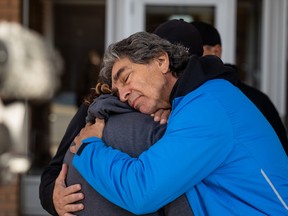 Gallagher hugs his daughter Lindsey Bishop outside the provincial courthouse after the appearance of one of four people charged in connection with his daughter Megan Gallagher's death.