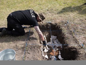 Christian Rouleau of the Quebec provincial police takes part in the field exercise of a simulated grave excavation — searching for evidence and imitation remains at the Warman Fire Department training grounds.