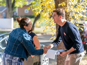 Nathaniel Teed, Saskatchewan NDP candidate for the Saskatoon Meewasin byelection, interacts with a person on byelection day in Saskatoon, Sask. on Monday, September 26, 2022.