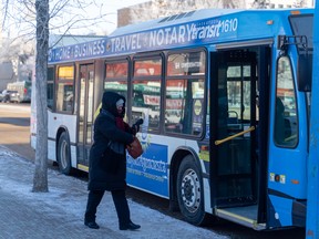 A pedestrian walks to the bus on Third Avenue North in Saskatoon, Sask. on Tuesday, February 22, 2022.