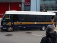 A supporter of a pro-democracy union waves at a prison van at the Wanchai district court in Hong Kong, Saturday, Sept. 10, 2022, where members of the union are sentenced for 19 months in jail for the charges of sedition for publishing children's books which allegedly try to explain the city's democracy movement using illustrations of sheep.