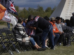 People hug before a press conference by officials at the James Smith Cree Nation on September 8, 2022. (Photo by LARS HAGBERG / AFP)