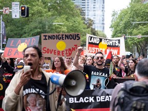 Activists attend a rally to decry colonial Britain's destructive impact on Indigenous people, as the country held a public holiday to mark the death of Queen Elizabeth II, in Sydney on September 22, 2022. (Photo by Andrew LEESON / AFP)