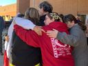 Family and loved ones of Megan Gallagher hugged outside Saskatoon provincial court on Monday, Sept. 26, 2022, after the first court appearance — by telephone — of Robert 
