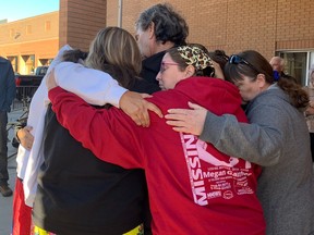 Family and loved ones of Megan Gallagher hugged outside Saskatoon provincial court on Monday, Sept. 26, 2022 (Bre McAdam / Saskatoon StarPhoenix)