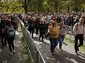 Thousands of people stand in line in Southwark Park to see Queen Elizabeth II lying in state at Westminster Hall on Friday.