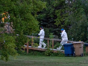 Investigators with protective equipment enter a house in a crime scene in Weldon, Sask., Sunday, Sept. 4, 2022. Saskatchewan RCMP has confirmed that there are 10 dead while 15 are injured following the stabbings that occurred at James Smith Cree Nation and Weldon in Saskatchewan.