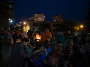 Mourners gather around a group of drummers during a vigil for the victims of a mass stabbing that left 11 dead and 17 wounded in the communities of James Smith Cree Nation and Weldon on Wednesday, September 7, 2022 in Prince Albert.