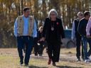 Gov.-Gen. Mary Simon, right, and Chief Wally Burns of James Smith Cree Nation walk during their visit the victims? gravesite of the mass stabbing incident at James Smith Cree Nation, Sask., on Wednesday, September 28, 2022.