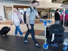 Rohi Rasa (left) and her husband Abdul Mojeeb Bari, both lawyers who worked in the Attorney’s General Office of Afghanistan, finally arrive at the Saskatoon International airport after three cancelled flights with the help of Nest — a volunteer-run organization that helps sponsor women activists from Afghanistan, who were forced to flee their homes due to their work for women’s equality. Photo taken in Saskatoon, Sask. on Tuesday, Aug. 30, 2022.