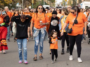 A wave of orange shirts filled Saskatoon as people walked from CUMFI to Victoria Park during the Rock Your Roots Walk for Reconciliation on National Truth and Reconciliation Day in Saskatoon on Sept. 30, 2022.
