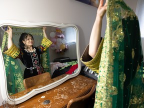 Rejna Ahmadi puts on a scarf that was sent to her from her fiancée M. Jawid Shoja. It symbolizes leaving her parents to live with him. Photo taken in Saskatoon on May 17, 2022.