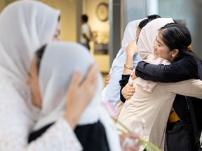 Rejna Ahmadi (right) and her family say their farewells before boarding their flight to Toronto at the Saskatoon International Airport on Aug. 27, 2022.