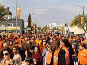 A wave of orange shirts filled Saskatoon as people walked from CUMFI to Victoria Park during the Rock Your Roots Walk for Reconciliation on National Truth and Reconciliation day in Saskatoon, Sask. on Sept. 30, 2022.