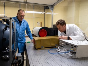 Doug Degenstein, left, and Adam Bourassa discuss their Aerosol Limb Imager, one of three new climate science instruments the University of Saskatchewan researchers are developing. The instruments will be launched into space as part of a NASA and CSA mission. Photo taken in Saskatoon, SK on Friday, October 21, 2022.