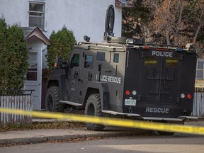 Saskatoon police at the scene of a shooting in the 1300 block of Avenue E N. Police fatally shot a person they say was armed on Thursday night after they responded to a report of shots being fired inside a multi-unit residential building.