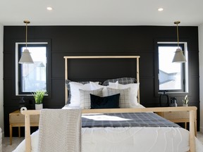 The master bedroom is a spacious retreat for the owners. A feature wall adds some design interest and tons of windows keep the space bright and airy.