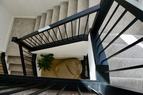 According to Cam Skoropat of Lexis Homes, visitors really admire the wide staircase leading to the second floor. Vertical windows add sunlight and design detail.