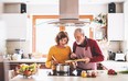 Senior couple preparing food in the kitchen.