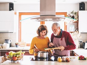 Senior couple preparing food in the kitchen.