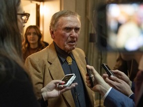 Former Saskatchewan politician Colin Thatcher who was convicted for the murder of his ex-wife, JoAnn Wilson, speaks to the media after exiting the house chambers after the Throne Speech inside the Saskatchewan Legislative Building on Wednesday, October 26, 2022 in Regina.