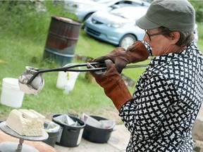 Paula Cooley fires a horse hair pot in 2022. (BearPaw Pottery)