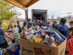 St. Joseph High School students load thousands of pounds of donated food into trucks as part of Halloweening for Hunger, the longstanding tradition of Greater Saskatoon Catholic Schools' students collecting non-perishable food for the Saskatoon Food Bank and Learning Centre.