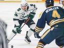 Saskatchewan Huskies forward Dawson Holt is expected to return from injury as he carries the puck on the ice under pressure from the Trinity Western Spartans during a Canada West Hockey game in Saskatoon on Friday, November 12, 2021.