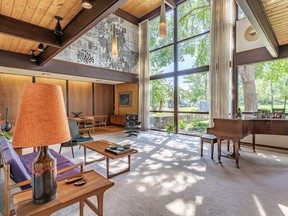 This magnificent home at 205 Copland Crescent in Saskatoon was designed in 1962 by renowned architect George Kerr as his personal residence. Twenty-foot-high windows in the open concept living room flood the home with natural light. PHOTO: LEE KOLENICK