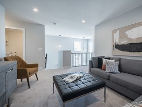 A bonus room at the top of the stairs overlooks the vaulted entrance, giving this home a touch of luxury.Photo by Scott Prokop