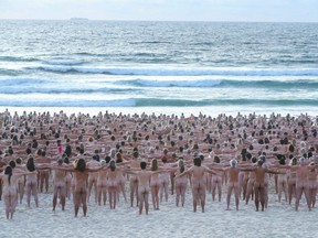 Members of the public pose at sunrise for photographic artist Spencer Tunick at Bondi Beach in Sydney, Australia, Saturday, Nov. 26, 2022.
