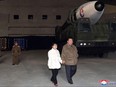 This picture taken on Nov. 18, 2022 and released from North Korea's official Korean Central News Agency (KCNA) on November 19, 2022 shows North Korea's leader Kim Jong Un walking with his daughter as he inspects a new intercontinental ballistic missile (ICBM) "Hwasong Gun 17", ahead of its launch at Pyongyang International Airport.