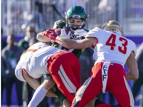 Jordin Rusnack of the Huskies catches a pass and is hit by Cristophe Beaulieu and C-A. Jacques during the first half of the Vanier Cup in London, Ont. Saturday. Mike Hensen/The London Free Press/Postmedia Network