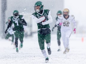 Huskies' receiver Rhett Vavra takes off down a snowy field during Saturday's playoff win over Manitoba.