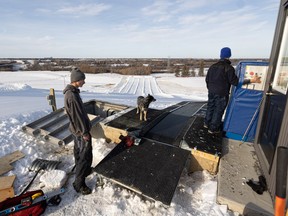 (From left) Matthew Wileniec and Dallas Ostrom do some final repairs on the lift at Optimist hill before it opens. Photo taken in Saskatoon, Sask. on Thursday, Nov 24, 2022.