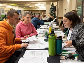 From left, Volodymyr Darda, 34, and Hannah Darda, 29, came from Krivi Lee, Ukraine, on Friday with the help of Sask Jobs' Daniel Young.