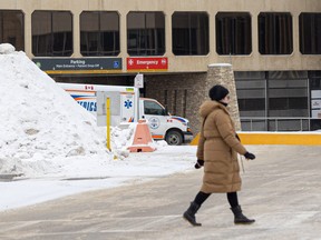 A pedestrian crosses the street near the Royal University Hospital. An alleged assault on a health care provider who was on her way to her car prompted the SEIU-West union to call on the province and the Saskatchewan Health Authority for safe parking options for hospital staff.