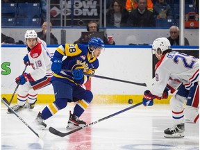 Saskatoon Blades centre Trevor Wong (38) carries the puck up the ice under pressure from Spokane Chiefs centre Tommaso De Luca (29)during WHL action in Saskatoon in December.